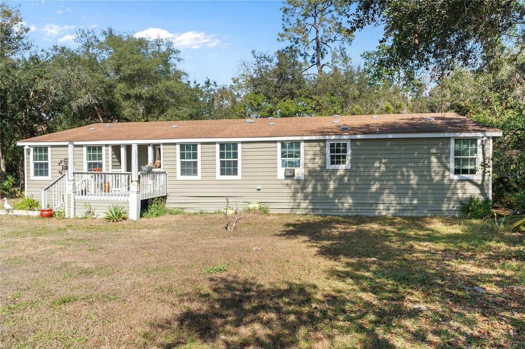 back of house with a yard and a deck