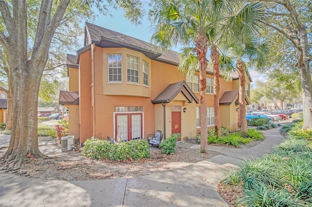 view of front of property with cooling unit and french doors