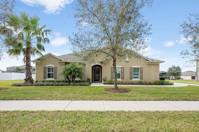 single story home with a front yard, fence, and stucco siding