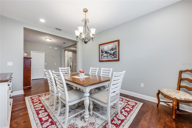 dining room featuring a notable chandelier, baseboards, visible vents, and dark wood-type flooring