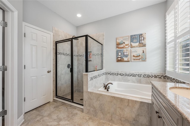 bathroom with recessed lighting, a garden tub, a shower stall, and vanity