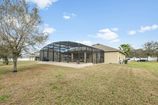 back of property with a patio area, a yard, and stucco siding