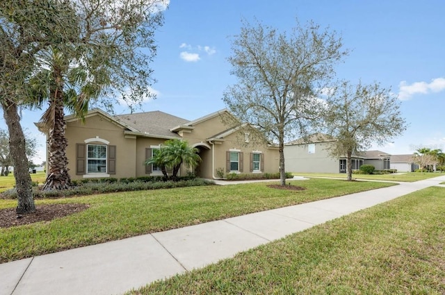 ranch-style house with a front lawn and stucco siding