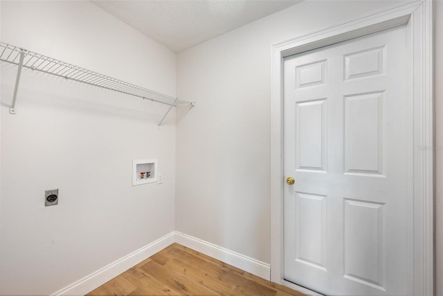 1001 Glencove Ave NW, Palm Bay, FL 32907 - laundry room featuring light wood finished floors, laundry area, hookup for a washing machine, baseboards, and electric dryer hookup