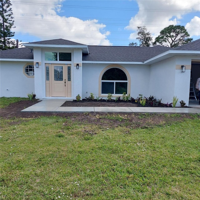 1001 Glencove Ave NW, Palm Bay, FL 32907 - view of front facade with stucco siding, roof with shingles, and a front yard