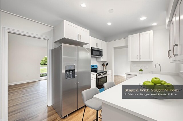 1001 Glencove Ave NW, Palm Bay, FL 32907 - kitchen featuring white cabinets, recessed lighting, stainless steel appliances, light countertops, and light wood-type flooring