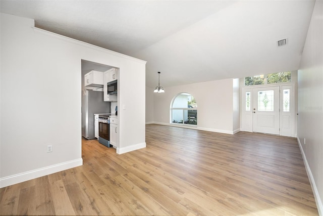 1001 Glencove Ave NW, Palm Bay, FL 32907 - unfurnished living room with baseboards, a notable chandelier, visible vents, and light wood-type flooring