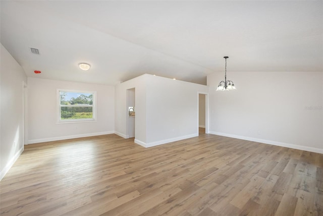 1001 Glencove Ave NW, Palm Bay, FL 32907 - spare room with light wood-style floors, visible vents, baseboards, and a notable chandelier