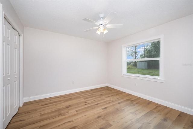 1001 Glencove Ave NW, Palm Bay, FL 32907 - unfurnished bedroom featuring light wood-style flooring, baseboards, a closet, and ceiling fan