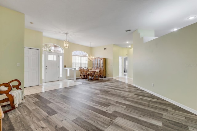 foyer entrance with a notable chandelier and light hardwood / wood-style floors