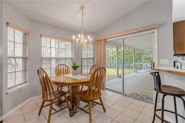 tiled dining space with a notable chandelier and lofted ceiling