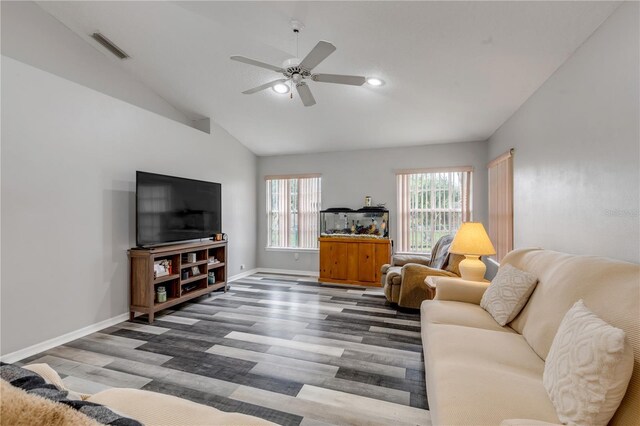 living room with ceiling fan, a wealth of natural light, wood-type flooring, and lofted ceiling