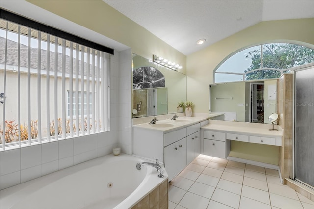 bathroom with tile patterned floors, vaulted ceiling, shower with separate bathtub, a textured ceiling, and vanity