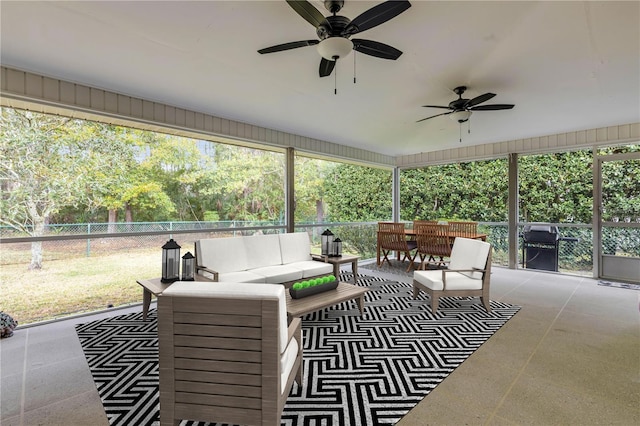 sunroom / solarium featuring ceiling fan