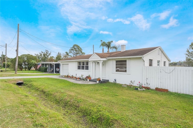 ranch-style home featuring a front yard, fence, an attached garage, a chimney, and concrete driveway