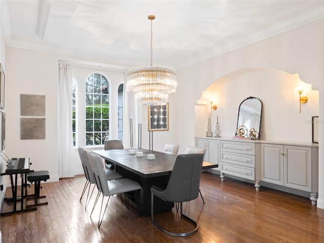 dining area featuring ornamental molding, dark hardwood / wood-style flooring, and a notable chandelier