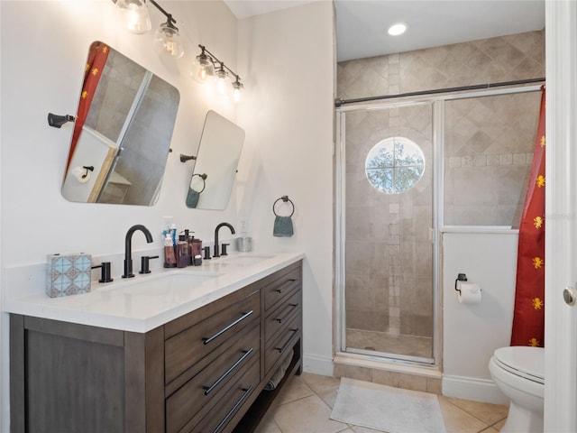 bathroom featuring tile patterned flooring, vanity, a shower with door, and toilet