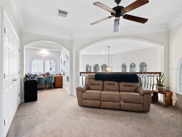 carpeted living room featuring ornamental molding and ceiling fan