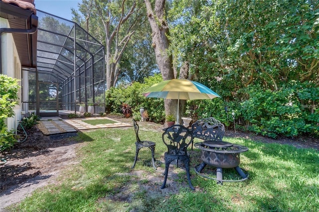 view of yard featuring a patio area and glass enclosure