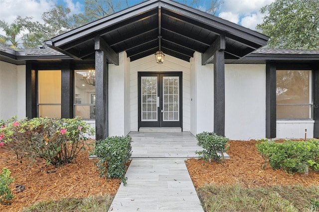 doorway to property featuring stucco siding and french doors