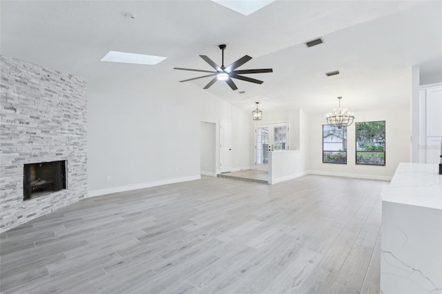 unfurnished living room featuring light wood-type flooring, visible vents, and a stone fireplace