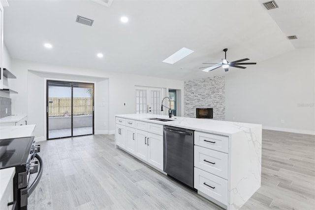 kitchen featuring range with electric stovetop, a sink, visible vents, white cabinets, and stainless steel dishwasher