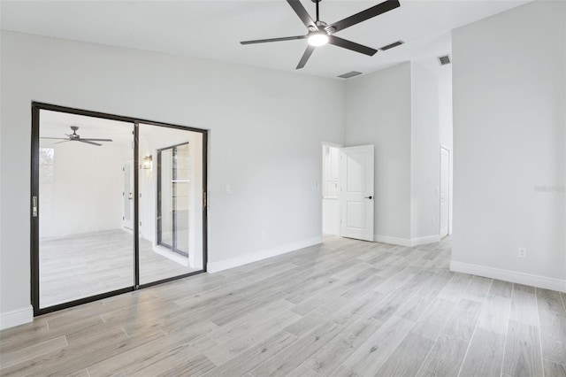 spare room featuring baseboards, visible vents, and light wood finished floors