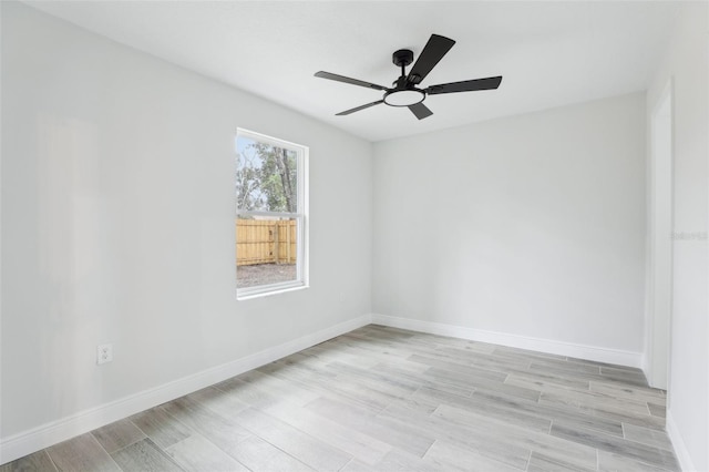 unfurnished room featuring a ceiling fan, light wood-style flooring, and baseboards