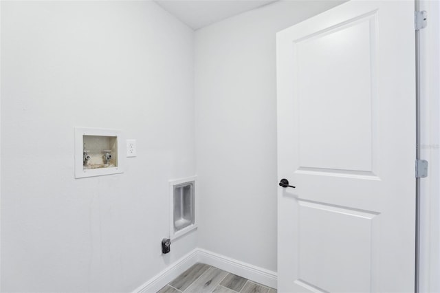 laundry area with light wood-style floors, washer hookup, laundry area, and baseboards