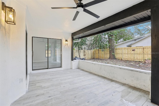 view of patio / terrace featuring fence and ceiling fan