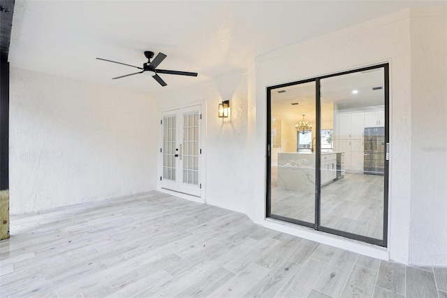 view of patio / terrace featuring ceiling fan and french doors