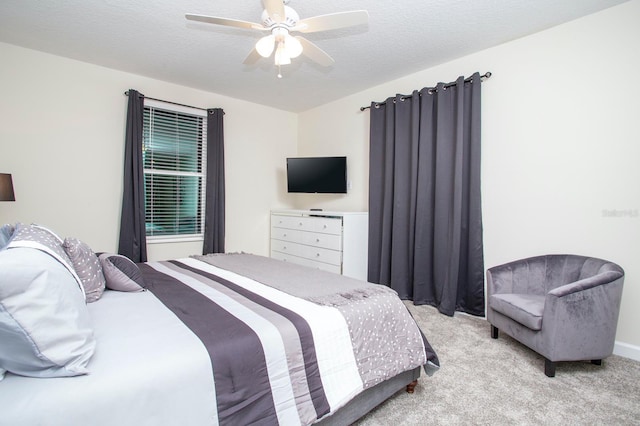 carpeted bedroom featuring a textured ceiling and a ceiling fan