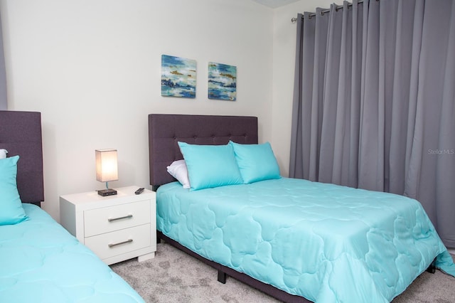 bedroom featuring light colored carpet