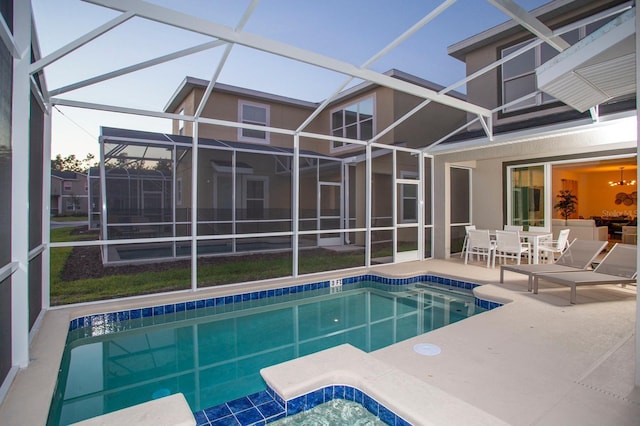 pool featuring a lanai and a patio area