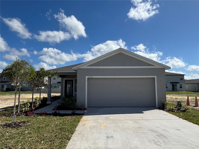 view of front of property featuring a garage and a front yard