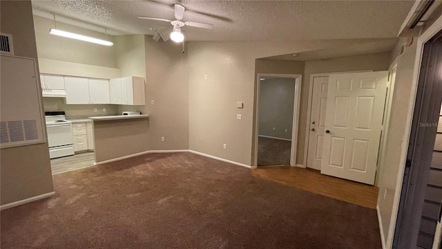 kitchen with white electric range, carpet flooring, white cabinets, ceiling fan, and a textured ceiling