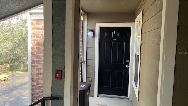 property entrance with brick siding