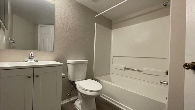 full bathroom with vanity, hardwood / wood-style flooring, toilet, and washtub / shower combination