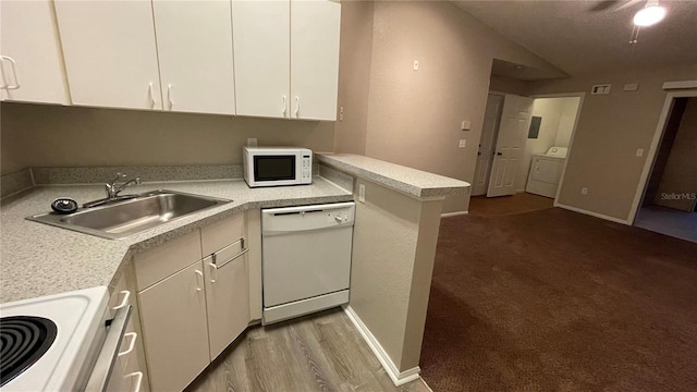 kitchen with washer / clothes dryer, sink, kitchen peninsula, white appliances, and light hardwood / wood-style flooring