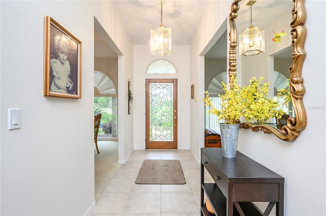 foyer featuring light tile patterned floors and a chandelier