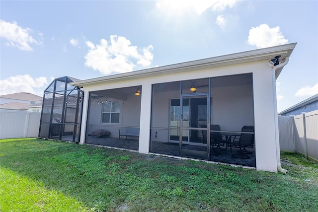 back of house with a sunroom and a yard