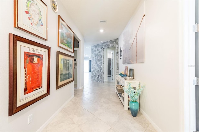 hall with light tile patterned floors