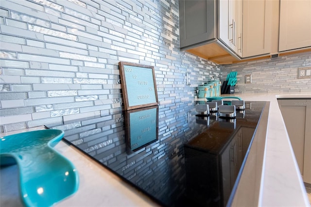 kitchen featuring gray cabinets and backsplash