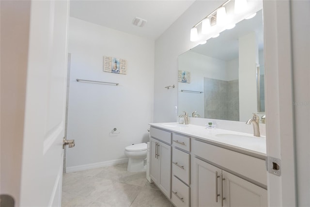 bathroom with vanity, tile patterned floors, a shower, and toilet