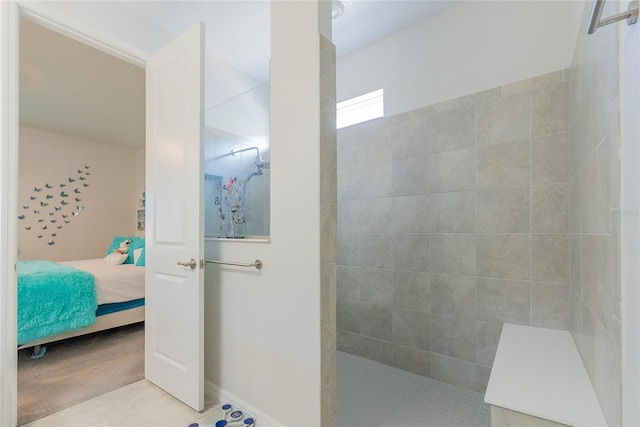 bathroom featuring tile patterned flooring and tiled shower