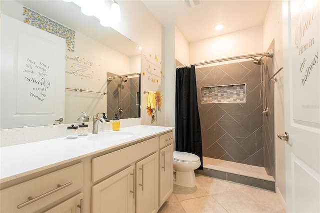 bathroom with vanity, curtained shower, tile patterned floors, and toilet