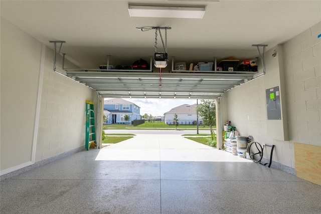 garage with a garage door opener and electric panel