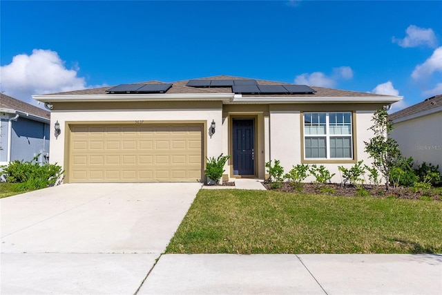 view of front of house featuring a garage, a front yard, and solar panels