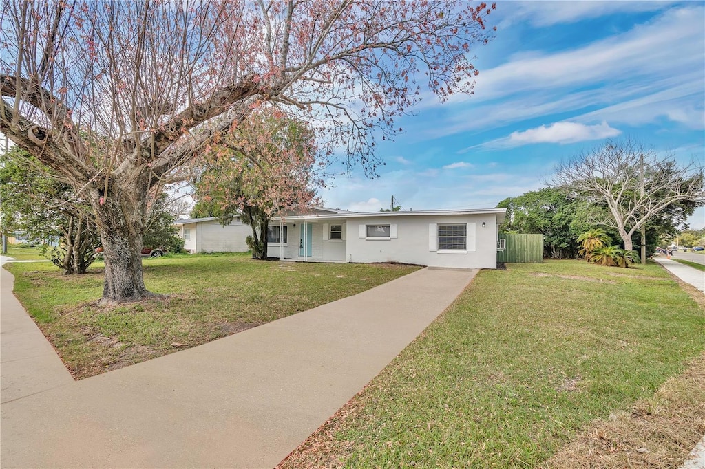 ranch-style home featuring a front yard