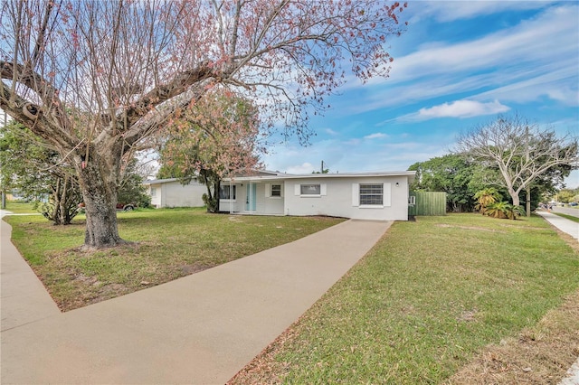 ranch-style home featuring a front yard